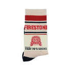 Firestone Walker "That 70's Socks" — cream crew socks with red and navy stripes, black toe and heel, red "Firestone" text.