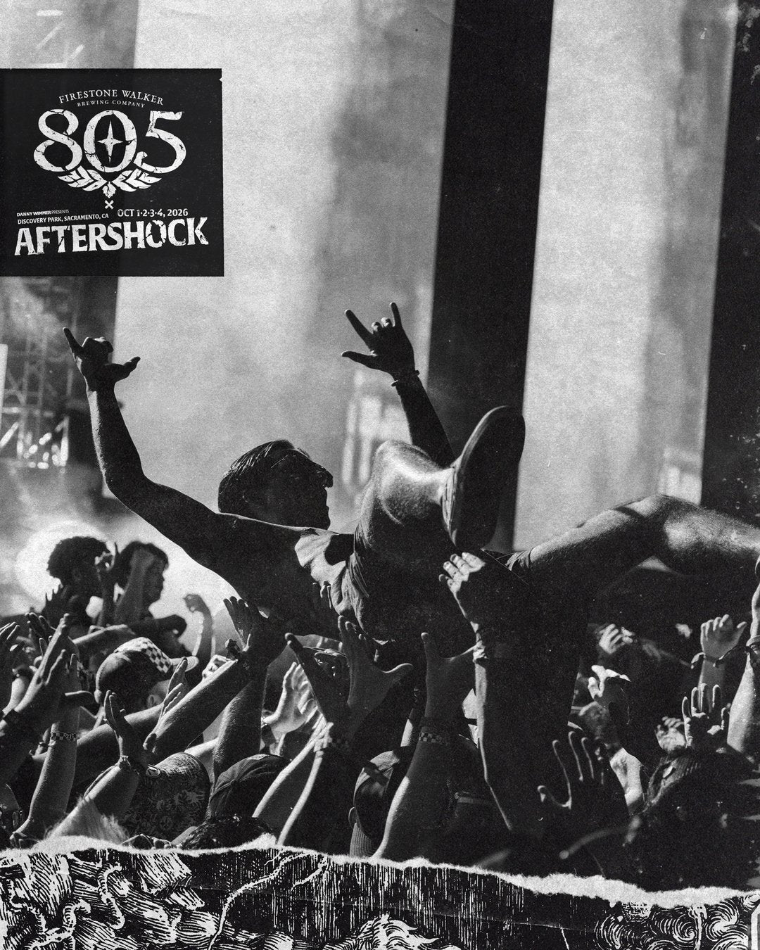 Black-and-white photo of a crowd surfer throwing up rock horns over a packed festival crowd, with the 805 x Aftershock logo for Discovery Park, Sacramento, October 1–4, 2026