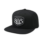 Firestone Walker 805 snapback hat, black with shield logo patch, angled left view