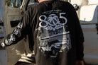 Man wearing 805 x Heat Wave "Properly Chill" long sleeve shirt, back print with off-road truck graphic, black